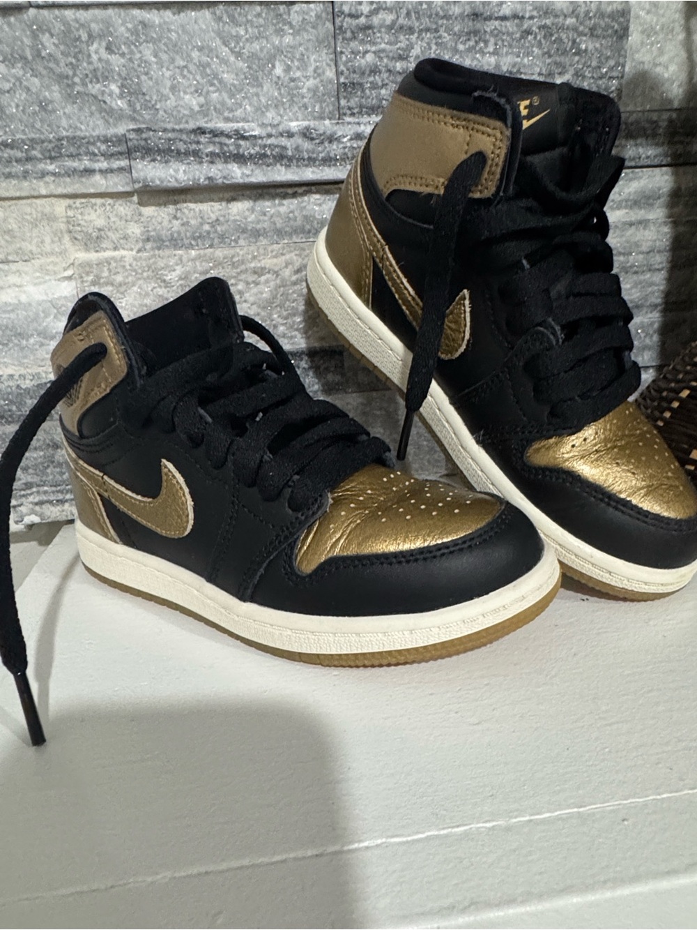 Jordan 1 Nike Black and Metallic Gold Mid-Top Sneakers